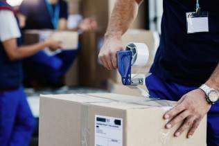 closeup-delivery-man-closing-carboard-box-with-tape-while-preparing-packages-shipment (1)