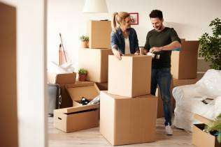 couple-packing-stuff-among-plenty-cardboard-boxes (1)