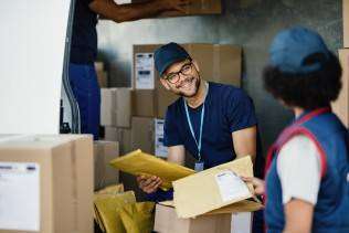 young-manual-worker-talking-his-female-colleague-while-sorting-packages-shipment-delivery-van (1)